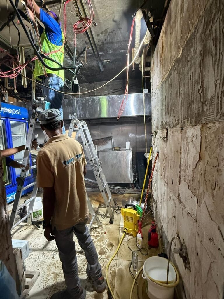 Little Lahore kitchen renovation before - technicians working on exhaust and electrical