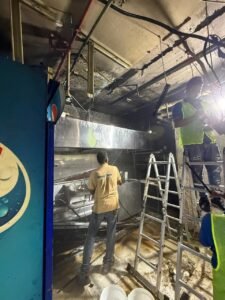 Teddy Tech technician cleaning Little Lahore exhaust hood
